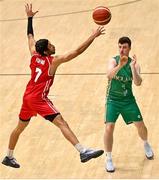 25 February 2024; Adrian O'Sullivan of Ireland in action against Selim Fofana of Switzerland during the FIBA Basketball World Cup 2027 European Pre-Qualifiers first round match between Ireland and Switzerland at the National Basketball Arena in Tallaght, Dublin. Photo by David Fitzgerald/Sportsfile