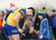 25 February 2024; Ruaidhrí Fallon of Roscommon signs an autograph for supporter Robert Fallon, aged 9, from Dysart in Roscommon after the Allianz Football League Division 1 match between Roscommon and Monaghan at Dr Hyde Park in Roscommon. Photo by Daire Brennan/Sportsfile