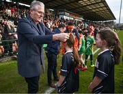 25 February 2024; Uachtarán Chumann Lúthchleas Gael Jarlath Burns presents a medal to Grace McKee of St John's PS, Middletown in Armagh, during half-time in the Allianz Football League Division 2 match between Armagh and Donegal at BOX-IT Athletic Grounds in Armagh. Photo by Brendan Moran/Sportsfile