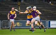 25 February 2024; Jack O'Connor of Wexford in action against Clare players Seán Rynne, left, and Cian Galvin during the Allianz Hurling League Division 1 Group A match between Wexford and Clare at Chadwicks Wexford Park in Wexford. Photo by Seb Daly/Sportsfile