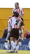 23 July 2004; Gareth McGlynn, hidden, Derry City, celebrates after scoring his sides first goal with team-mates Sean Hargan, top, and Damien Brennan (2). FAI Carlsberg Cup, Second Round, Galway United v Derry City, Terryland Park, Galway. Picture credit; David Maher / SPORTSFILE