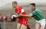 24 July 2004; Conleth Moran, Derry, is tackled by Limerick's Connor Mullane. Bank of Ireland Senior Football Championship Qualifier, Round 4, Derry v Limerick, Dr. Hyde Park, Roscommon. Picture credit; Pat Murphy / SPORTSFILE