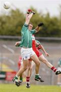 24 July 2004; Jason Stokes, Limerick, is tackled by Derry's Patsy Bradley. Bank of Ireland Senior Football Championship Qualifier, Round 4, Derry v Limerick, Dr. Hyde Park, Roscommon. Picture credit; Pat Murphy / SPORTSFILE