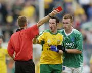 24 July 2004; Referee Joe McQuillan issues the red card to Donegal's Brendan Devenney, as Fermanagh's Martin McGrath attempts to restrain Devenney. Bank of Ireland Senior Football Championship Qualifier, Round 4, Fermanagh v Donegal, Tighernach's Park, Clones. Co. Monaghan. Picture credit; Damien Eagers / SPORTSFILE