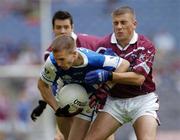 24 July 2004; Joe Higgins, Laois, attempts to clear under pressure from Westmeath's Alan Mangan, right, and Brian Morley. Bank of Ireland Leinster Senior Football Championship Final Replay, Westmeath v Laois, Croke Park, Dublin. Picture credit; Ray McManus / SPORTSFILE