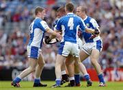 24 July 2004; Alan Mangan, Westmeath, is tackled by Laois players Brian McDonald, left, Paul McDonald (4), and Tom Kelly. Bank of Ireland Leinster Senior Football Championship Final Replay, Westmeath v Laois, Croke Park, Dublin. Picture credit; Ray McManus / SPORTSFILE