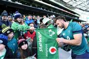 29 February 2024; Caelan Doris signs autographs for young supporters after an Ireland rugby training session at the Aviva Stadium in Dublin. Photo by Matt Browne/Sportsfile