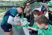 29 February 2024; Garry Ringrose signs autographs for young supporters after an Ireland rugby training session at the Aviva Stadium in Dublin. Photo by Matt Browne/Sportsfile