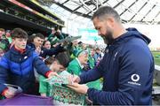 29 February 2024; Head coach Andy Farrell signs autographs for young supporters after an Ireland rugby training session at the Aviva Stadium in Dublin. Photo by Matt Browne/Sportsfile