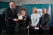 29 February 2024; Sally Kavanagh of Waterford Hockey Club, Waterford, second from left, receives her award from Minister of State for Sport and Physical Education Thomas Byrne TD, left, Federation of Irish Sport chair Clare McGrath, second from right, and Louth Sports Partnership and Louth County Council head of sport, Federation of Irish Sport board member and member of the Awards Judging Panel Graham Russell, during the Federation of Irish Sport Volunteers in Sport Awards at The Crowne Plaza Hotel in Blanchardstown, Dublin Photo by Seb Daly/Sportsfile
