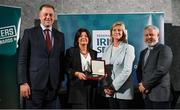 29 February 2024; Dee Quin, second from left, receives her award, from behalf of her husband David Quin of Dunshaughlin Youths Football Club, Meath, from Minister of State for Sport and Physical Education Thomas Byrne TD, left, Federation of Irish Sport chair Clare McGrath, second from right, and Louth Sports Partnership and Louth County Council head of sport, Federation of Irish Sport board member and member of the Awards Judging Panel Graham Russell, during the Federation of Irish Sport Volunteers in Sport Awards at The Crowne Plaza Hotel in Blanchardstown, Dublin. Photo by Seb Daly/Sportsfile