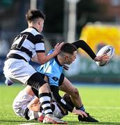 29 February 2024; \is tackled by \during the Bank of Ireland Leinster Schools Junior Cup quarter-final match between St Michael's College and Belvedere College at Energia Park in Dublin. Photo by Daire Brennan/Sportsfile