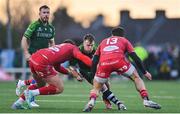 2 March 2024; David Hawkshaw of Connacht is tackled by Eddie James, left, and Johnny Williams of Scarlets during the United Rugby Championship match between Connacht and Scarlets at Dexcom Stadium in Galway. Photo by Stephen Marken/Sportsfile