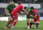 2 March 2024; Caolin Blade of Connacht is tackled by Dan Jones, left, and Jac Price of Scarlets during the United Rugby Championship match between Connacht and Scarlets at Dexcom Stadium in Galway. Photo by Stephen Marken/Sportsfile