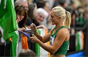 3 March 2024; Sarah Lavin of Ireland sign autographs for supporters after her heat of the Women's 60m hurdles during day three of the World Indoor Athletics Championships 2024 at Emirates Arena in Glasgow, Scotland. Photo by Sam Barnes/Sportsfile