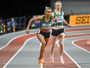 3 March 2024; Sharlene Mawdsley of Ireland, left, takes the baton from team-mate Roisin Harrison whilst competing in the women's 4x400m relay during day three of the World Indoor Athletics Championships 2024 at Emirates Arena in Glasgow, Scotland. Photo by Sam Barnes/Sportsfile