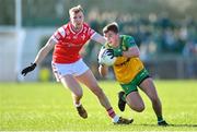 3 March 2024; Peadar Mogan of Donegal in action against Paul Matthews of Louth during the Allianz Football League Division 2 match between Donegal and Louth at Fr Tierney Park in Ballyshannon, Donegal. Photo by David Fitzgerald/Sportsfile