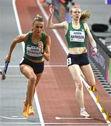 3 March 2024; Sharlene Mawdsley of Ireland takes the baton from teammate Róisín Flanagan during the Women's 4 x 400m Relay Final on day three of the World Indoor Athletics Championships 2024 at Emirates Arena in Glasgow, Scotland. Photo by Sam Barnes/Sportsfile