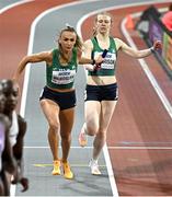 3 March 2024; Sharlene Mawdsley of Ireland takes the baton from teammate Roisin Harrison during the Women's 4 x 400m Relay Final on day three of the World Indoor Athletics Championships 2024 at Emirates Arena in Glasgow, Scotland. Photo by Sam Barnes/Sportsfile