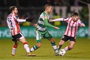 4 March 2024; Graham Burke of Shamrock Rovers in action against Paul McMullan, left, and Adam O'Reilly of Derry City during the SSE Airtricity Men's Premier Division match between Shamrock Rovers and Derry City at Tallaght Stadium in Dublin. Photo by Stephen McCarthy/Sportsfile