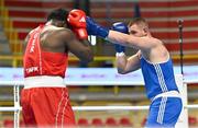 6 March 2024; Nelvie Raman Tiafack of Germany, left, in action against Jure Simunovic of Slovenia during their Men's 92kg+ Round of 32 bout during day four at the Paris 2024 Olympic Boxing Qualification Tournament at E-Work Arena in Busto Arsizio, Italy. Photo by Ben McShane/Sportsfile