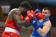 6 March 2024; Nelvie Raman Tiafack of Germany, left, in action against Jure Simunovic of Slovenia during their Men's 92kg+ Round of 32 bout during day four at the Paris 2024 Olympic Boxing Qualification Tournament at E-Work Arena in Busto Arsizio, Italy. Photo by Ben McShane/Sportsfile