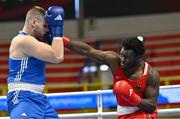 6 March 2024; Nelvie Raman Tiafack of Germany, right, in action against Jure Simunovic of Slovenia during their Men's 92kg+ Round of 32 bout during day four at the Paris 2024 Olympic Boxing Qualification Tournament at E-Work Arena in Busto Arsizio, Italy. Photo by Ben McShane/Sportsfile