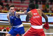 7 March 2024; Aidan Walsh of Ireland, left, in action against Wanderson De Oliveira of Brazil during their Men's 71kg Round of 32 bout during day five at the Paris 2024 Olympic Boxing Qualification Tournament at E-Work Arena in Busto Arsizio, Italy. Photo by Ben McShane/Sportsfile
