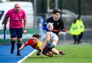 7 March 2024; Ted Duke of The High School evades the tackle of Oisin Kelly of St Fintan's High School during the Bank of Ireland Vinnie Murray Cup final match between St Fintan's High School and The High School at Energia Park in Dublin. Photo by Tyler Miller/Sportsfile