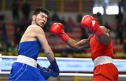 8 March 2024; Prewa Padabadi of Togo, right, in action against Nurbek Oralbay of Kazakhstan during their Men's 80kg Round of 32 bout during day six at the Paris 2024 Olympic Boxing Qualification Tournament at E-Work Arena in Busto Arsizio, Italy. Photo by Ben McShane/Sportsfile