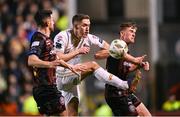 8 March 2024; John Martin of Shelbourne in action against Cian Byrne, right, and Jordan Flores of Bohemians during the SSE Airtricity Men's Premier Division match between Bohemians and Shelbourne at Dalymount Park in Dublin. Photo by Stephen McCarthy/Sportsfile