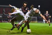 8 March 2024; Gavin Molloy, left, and Mark Coyle of Shelbourne are tackled by Dylan Connolly of Bohemians during the SSE Airtricity Men's Premier Division match between Bohemians and Shelbourne at Dalymount Park in Dublin. Photo by Shauna Clinton/Sportsfile
