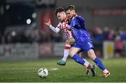 8 March 2024; Barry Baggley of Waterford in action against Adam O'Reilly of Derry City during the SSE Airtricity Men's Premier Division match between Derry City and Waterford at The Ryan McBride Brandywell Stadium in Derry. Photo by Ramsey Cardy/Sportsfile
