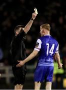 8 March 2024; Alec Byrne of Treaty United is shown a yellow card by referee Declan Toland during the SSE Airtricity Men's First Division match between Treaty United and Bray Wanderers at Markets Field in Limerick. Photo by Michael P Ryan/Sportsfile
