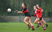9 March 2024; Molly Comerford of UCC in action against Aoife McTaggart of MTU Cork during the 2024 Ladies HEC Lynch Cup final match between Munster Technological University Cork and University College Cork at MTU Cork. Photo by Brendan Moran/Sportsfile