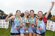 9 March 2024; The Presentation Kilkenny team, from left, Amy O'Shea, Eimear Cozmack, Katie O'Shea and Clodagh O'Callaghhan celebrate with the cup after winning the inter girls 3500m team event during the 123.ie All Ireland Schools Cross Country Championships at Tymon Park in Tallaght, Dublin. Photo by Sam Barnes/Sportsfile