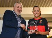 9 March 2024; Emily Lacey of UCC is presented with the Player of the Match by LGFA HEC chairperson Daniel Caldwell after the 2024 Ladies HEC Lynch Cup final match between Munster Technological University Cork and University College Cork at MTU Cork. Photo by Brendan Moran/Sportsfile