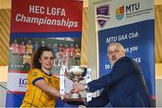 9 March 2024; DCU Dochas Éireann captain Emma Duggan is presented with the cup by LGFA HEC chairperson Daniel Caldwell after the 2024 Ladies HEC O’Connor Cup final match between Dublin City University Dóchas Éireann and University College Cork at MTU Cork. Photo by Brendan Moran/Sportsfile