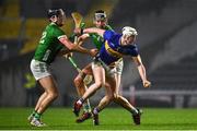 9 March 2024; Eoghan Connolly of Tipperary in action against Conor Boylan, left, and Gearoid Hegarty of Limerick during the Allianz Hurling League Division 1 Group B match between Limerick and Tipperary at SuperValu Páirc Uí Chaoimh in Cork. Photo by Seb Daly/Sportsfile