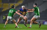 9 March 2024; Eoghan Connolly of Tipperary in action against Limerick players Conor Boylan, left, and Gearoid Hegarty during the Allianz Hurling League Division 1 Group B match between Limerick and Tipperary at SuperValu Páirc Uí Chaoimh in Cork. Photo by Seb Daly/Sportsfile