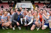 9 March 2024; Brother Darragh and sister Aoife, of the late Ella O'Neill, with the Moynihan Cup, and the ATU Sligo team sing 'Travelling Soldier' in her memory after the 2024 Ladies HEC Moynihan Cup final match between Atlantic Technological University Sligo and Mary Immaculate College Limerick at MTU Cork. Photo by Brendan Moran/Sportsfile