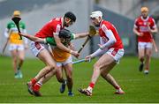 10 March 2024; David Nally of Offaly is tackled by Robert Downey, left, and Tim O'Mahony of Cork during the Allianz Hurling League Division 1 Group A match between Offaly and Cork at Glenisk O'Connor Park in Tullamore, Offaly. Photo by Tyler Miller/Sportsfile