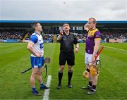 10 March 2024; Referee Colm Lyons with James Barron of Waterford and Simon Donohoe of Wexford before the Allianz Hurling League Division 1 Group A match between Waterford and Wexford at Walsh Park in Waterford. Photo by Seb Daly/Sportsfile