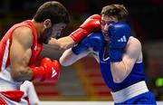 11 March 2024; Jude Gallagher of Ireland, right, in action against Shukur Ovezov of Turkmenistan during their Men's 57kg Quarterfinals bout during day nine at the Paris 2024 Olympic Boxing Qualification Tournament at E-Work Arena in Busto Arsizio, Italy. Photo by Ben McShane/Sportsfile