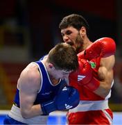 11 March 2024; Jude Gallagher of Ireland, left, in action against Shukur Ovezov of Turkmenistan during their Men's 57kg Quarterfinals bout during day nine at the Paris 2024 Olympic Boxing Qualification Tournament at E-Work Arena in Busto Arsizio, Italy. Photo by Ben McShane/Sportsfile