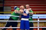 11 March 2024; Jude Gallagher of Ireland, celebrates after qualifying for the Olympics after winning their Men's 57kg Quarterfinals bout against Shukur Ovezov of Turkmenistan, with Ireland coaches Zaur Antia, right, and Damian Kennedy, centre, during day nine at the Paris 2024 Olympic Boxing Qualification Tournament at E-Work Arena in Busto Arsizio, Italy. Photo by Ben McShane/Sportsfile