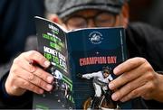 12 March 2024; A racegoer studies the racecard prior to racing on day one of the Cheltenham Racing Festival at Prestbury Park in Cheltenham, England. Photo by David Fitzgerald/Sportsfile