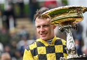 12 March 2024; Jockey Paul Townend celebrates with the Unibet Champion Hurdle Challenge Trophy after victory with State Man on day one of the Cheltenham Racing Festival at Prestbury Park in Cheltenham, England. Photo by David Fitzgerald/Sportsfile