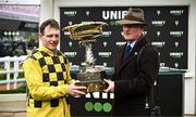 12 March 2024; Jockey Paul Townend and trainer Willie Mullins celebrate with the Unibet Champion Hurdle Challenge Trophy after victory with State Man on day one of the Cheltenham Racing Festival at Prestbury Park in Cheltenham, England. Photo by Harry Murphy/Sportsfile