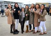 13 March 2024; Racegoers from Antrim and Armagh, from left, Grace Finnegan, Grace Brown, Erin Thompson, Eimear Dunne, Ava McAleese, Beth Johnson and Caoimhe Gormley on day two of the Cheltenham Racing Festival at Prestbury Park in Cheltenham, England. Photo by David Fitzgerald/Sportsfile